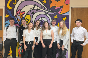  students posing in front of mural at NPHS